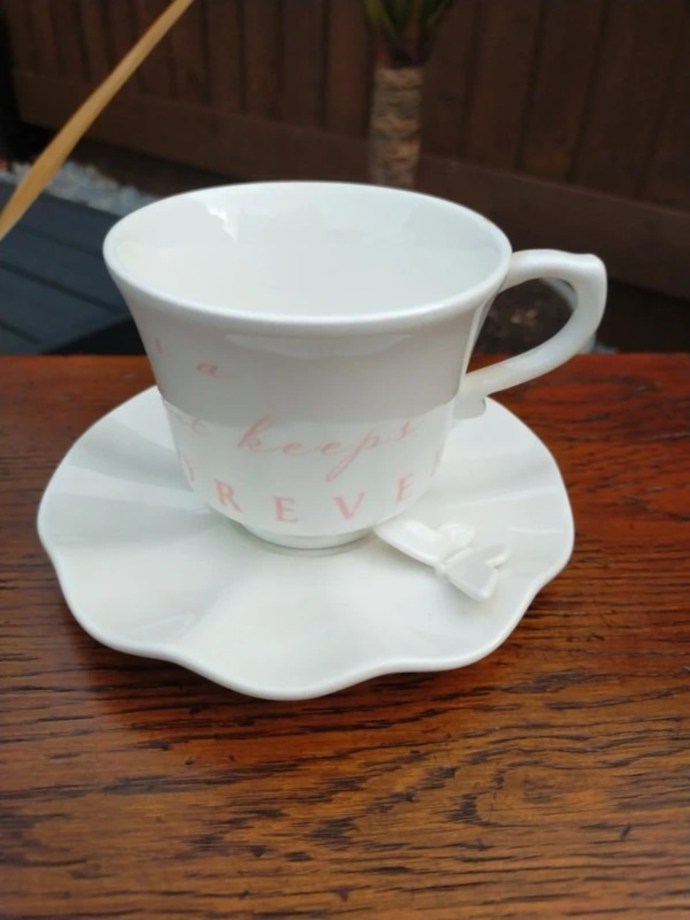 White Ceramic Teacup and Saucer Set with Soft Pink Script